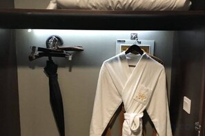 A hotel room with a bed, a robe hanging on a rack, and a towel hanging on a hook. - Century Yuan International hotel(Jiangyan,Taizhou) (Taizhou)