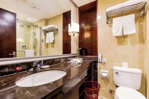 A bathroom with a marble sink, a mirror, a toilet, and a towel rack. - Century Yuan International hotel(Jiangyan,Taizhou) (Taizhou)