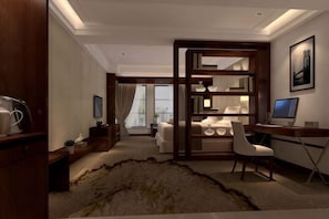 A modern hotel room with a large window, a desk with a computer, a chair, a sofa, and a decorative rug. - Century Yuan International hotel(Jiangyan,Taizhou) (Taizhou)