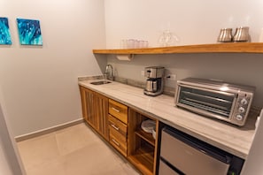 Fridge, microwave, coffee/tea maker, cookware/dishes/utensils