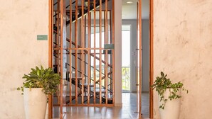 A hotel entrance with a wooden gate, potted plants, and a doormat. - Villa&Tower -17 Bdrms,sleeps 55-AC,Elevator,Pool (Quepos)