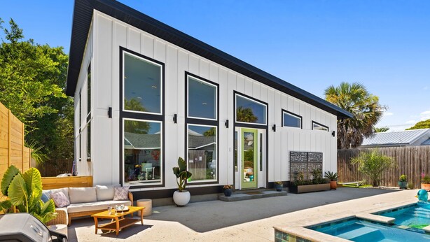 A modern house with a pool, large windows, and a patio area. - 2 Homes 1 Incredible Stay*Private Pool & 5 Kings! (Panama City Beach)