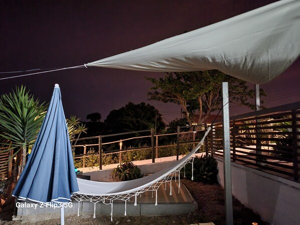 A hammock under a white canopy, a blue umbrella, and a wooden fence. - tiny house in the nature , near of beautiful beaches (Setubal)