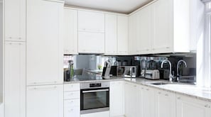 Enjoy cooking in this well-equipped kitchen with an oven, sink, and coffee maker.