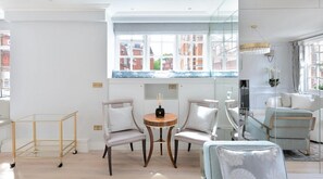 Relax in a stylish space with a seating area, large window, and elegant decor.