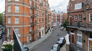 Experience classic urban living in a traditional neighborhood with historic red brick buildings and bay windows.