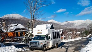 A white RV with 'South Peak' branding parked on a snow-covered road. - Riverfront Condo w/ Hot Tub | River Swimming Spot! (Lincoln)