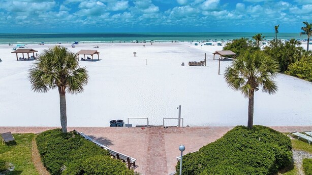 A beach with white sand, palm trees, and clear blue sky. - Beautiful Ground Floor 1bed/1.5 Bath Condo with Pool and Beach Access! (Siesta Key)