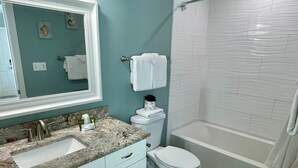 A bathroom with a sink, toilet, and bathtub. - Beachgate Condo Suites And Hotel 231+232+233 3 Bedroom Condo (Port Aransas)