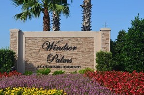 Welcome to Windor Palms, a serene community with beautifully maintained gardens and a clear entrance sign.