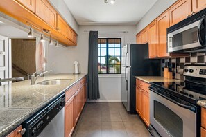 Condo, 2 Bedrooms | Private kitchen | Fridge, oven, coffee/tea maker
