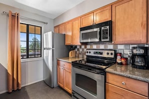 Condo, 2 Bedrooms | Private kitchen | Fridge, oven, coffee/tea maker