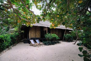 A thatched-roof hut with two lounge chairs in front. - Whale Island Resort (Nha Trang)