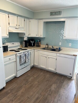 Enjoy cooking in this well-equipped kitchen with an oven, dishwasher, and coffee maker.
