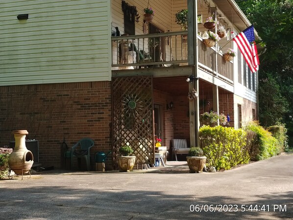 A two-story house with a porch, a large decorative gate, and an American flag. - Pleasant Hill Getaway in a secluded small neighborhood  (Franklin)