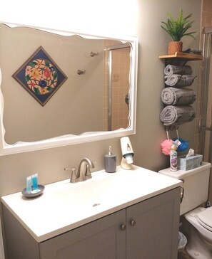 A bathroom with a sink, mirror, and towel rack. - Pleasant Hill Getaway in a secluded small neighborhood  (Franklin)
