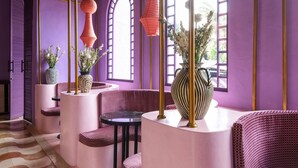A modern interior with curved seating, a patterned floor, and large arched windows. - El Barrio Boutique Hotel & Bar (Kerobokan)