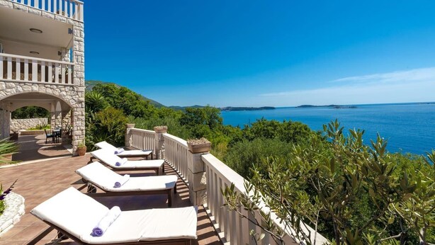 A balcony with lounge chairs overlooking a scenic view of the sea and hills. - Private Seaside Villa Sleeps 10 with Infinity Pool (Mlini)