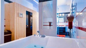 A modern bathroom with a large bathtub, wooden panel walls, and a glass shower enclosure. - Private Seaside Villa Sleeps 10 with Infinity Pool (Mlini)