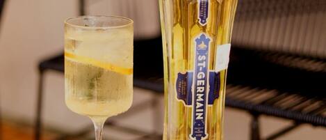 A bottle of St. Germain wine and a glass of wine on a table.