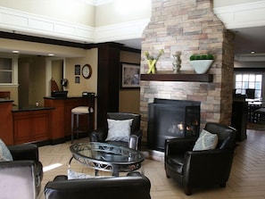 Relax in a comfortable living area with a fireplace, leather sofas, and a coffee table.