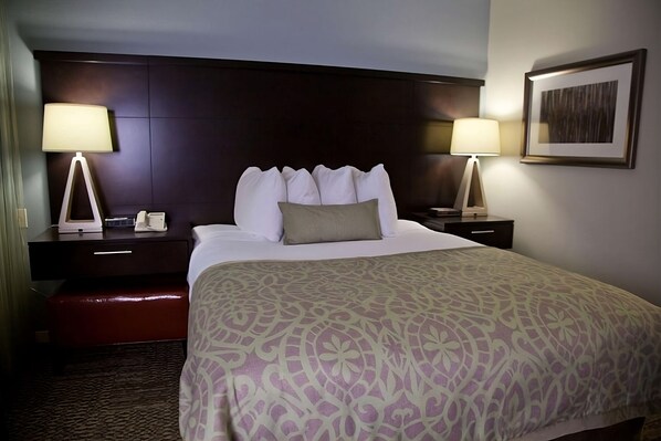 Relax in comfort with a large bed, bedside tables, and a stylish headboard.