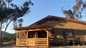 A rustic building with a wooden porch and a brick facade. - Unique Adobe Sanctuary w/hot tub close to hiking trails & wineries (San Marcos)