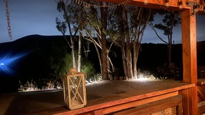 A wooden structure with a carved panel, a lantern, and string lights. - Unique Adobe Sanctuary w/hot tub close to hiking trails & wineries (San Marcos)