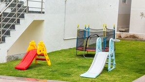 A playground with two slides and a climbing net. - TIO HOTELS & RESORTS - YERCAUD  (Yercaud)