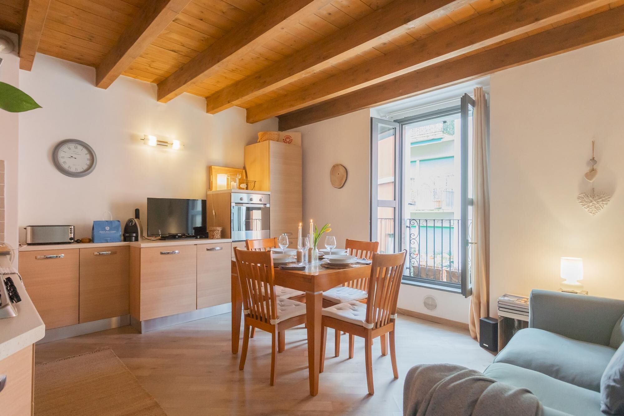 A compact living space with a kitchen, dining area, and a balcony.