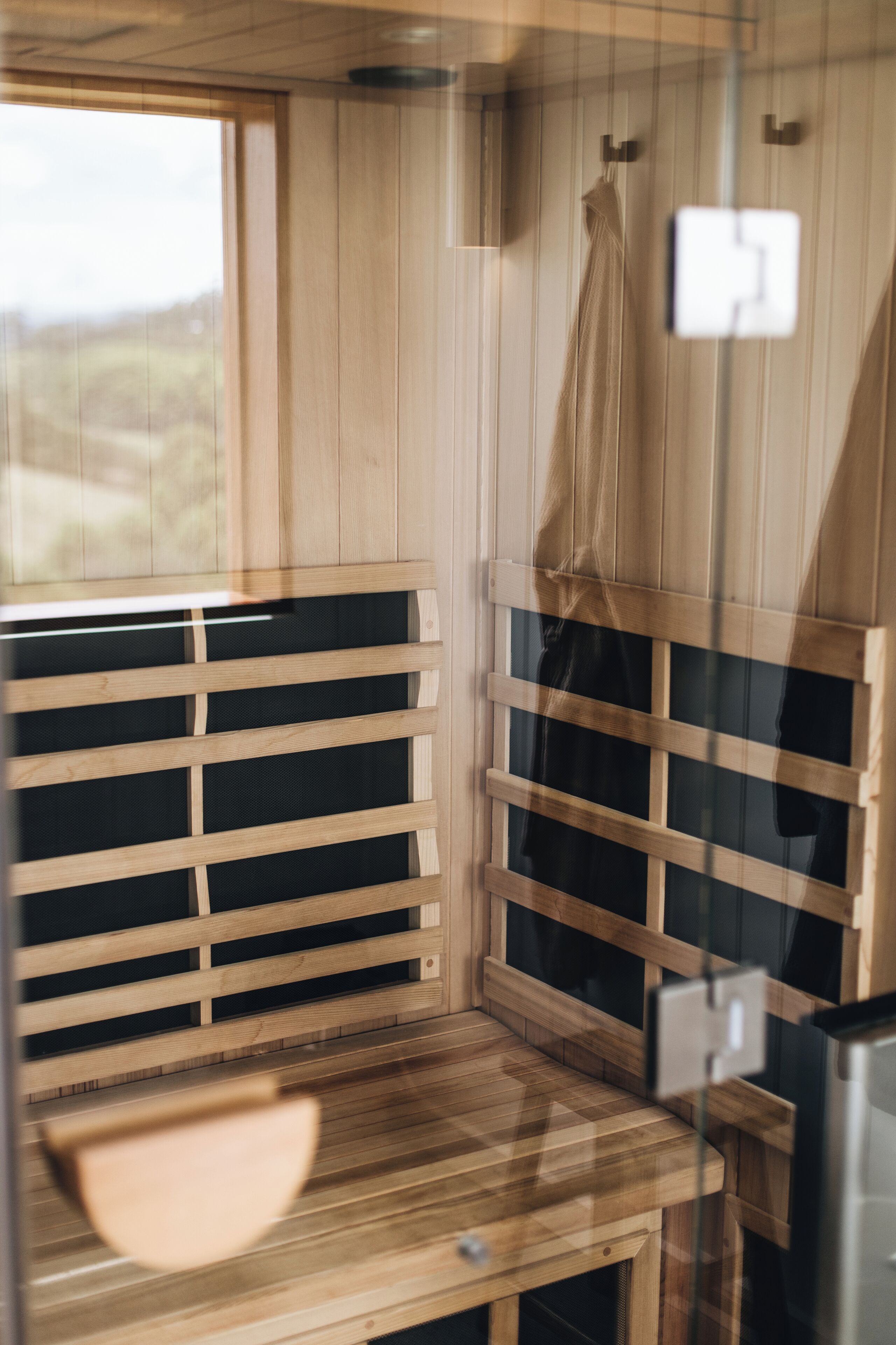 A wooden sauna with benches and a bench seat.
