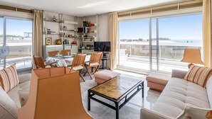 En rummelig stue med balkon, spiseområde og TV.