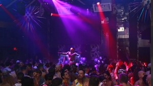 A crowded indoor event with a stage and audience. - Wilton Manors Guesthouse #4 (Wilton Manors)