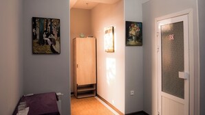 A hallway with a wooden wardrobe, a door with a frosted glass panel, and two paintings on the walls. - Old Radio  (Samarkand)