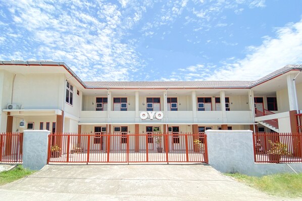 A two-story building with a flat roof and a sign that reads "OYO".