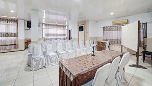 A conference room with a large table, chairs, and a podium.