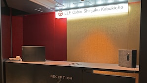 A reception desk with a sign indicating "ELE Cabin Shinjuku Kabukicho" and a note specifying "5-7 WOMEN, B1-2-4 MEN". - ELE Cabin Shinjuku Kabukicho (Tokyo)