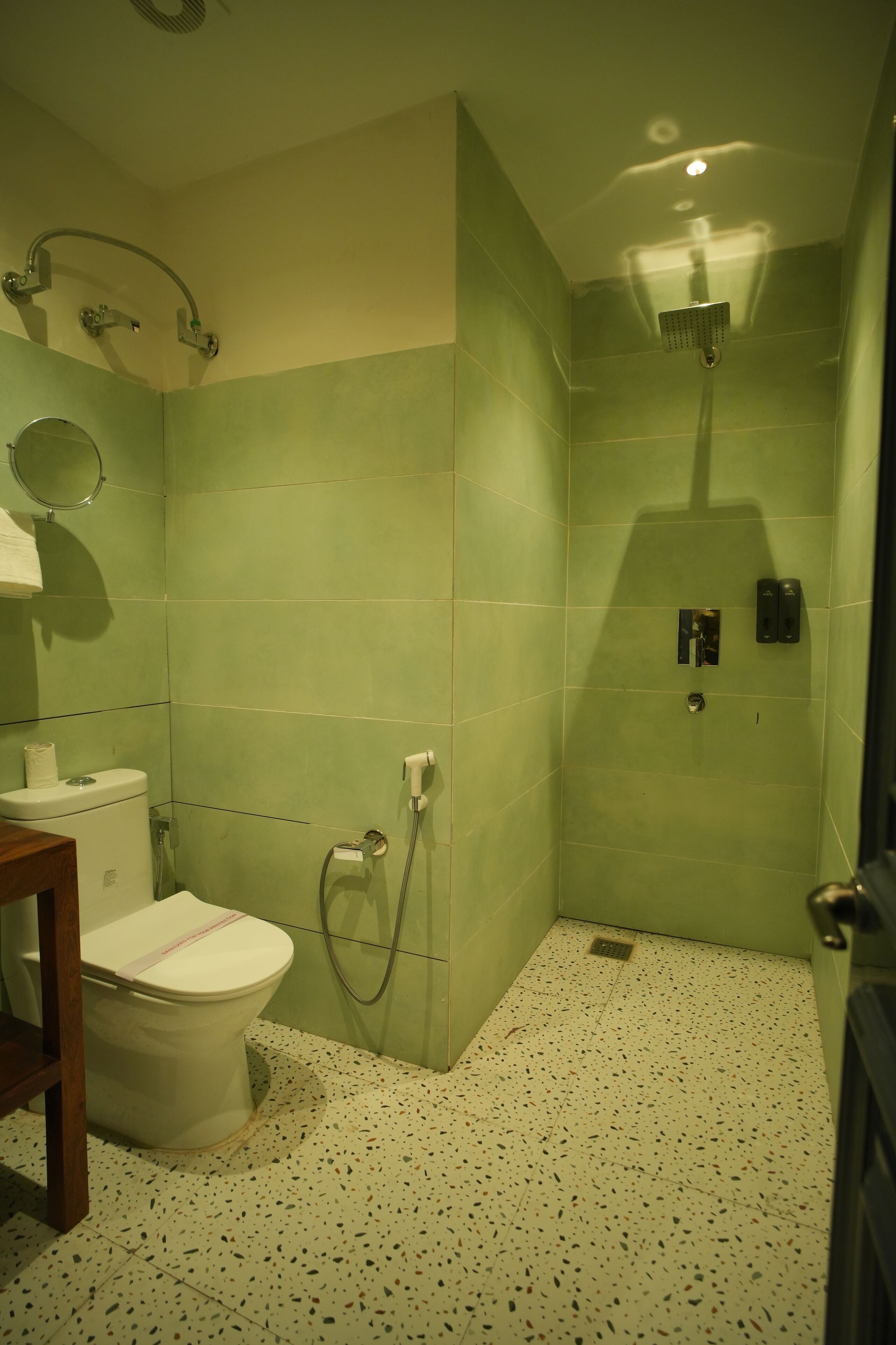 A bathroom with a toilet, a shower, and a sink.