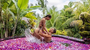 A couple in a water feature surrounded by tropical plants. - Wana Bucu Villas by GenuineHost (Ubud)