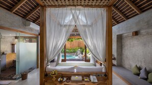 A bedroom with a view of a swimming pool, a wooden ceiling, and a bed with a bedside table. - Wana Bucu Villas by GenuineHost (Ubud)