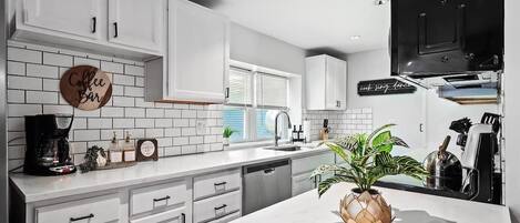 Fridge, stovetop, dishwasher, coffee/tea maker