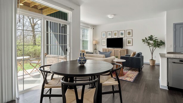 A modern living room with a dining area, large windows, a flat-screen TV, and a kitchen area. - Dublin 2BR | Pets welcome | Ground Floor | Views (Dublin)