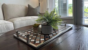 A wooden coffee table with a tray, a potted plant, and a small succulent. - Dublin 1BR | Pets OK | King bed | 0 stairs (Dublin)