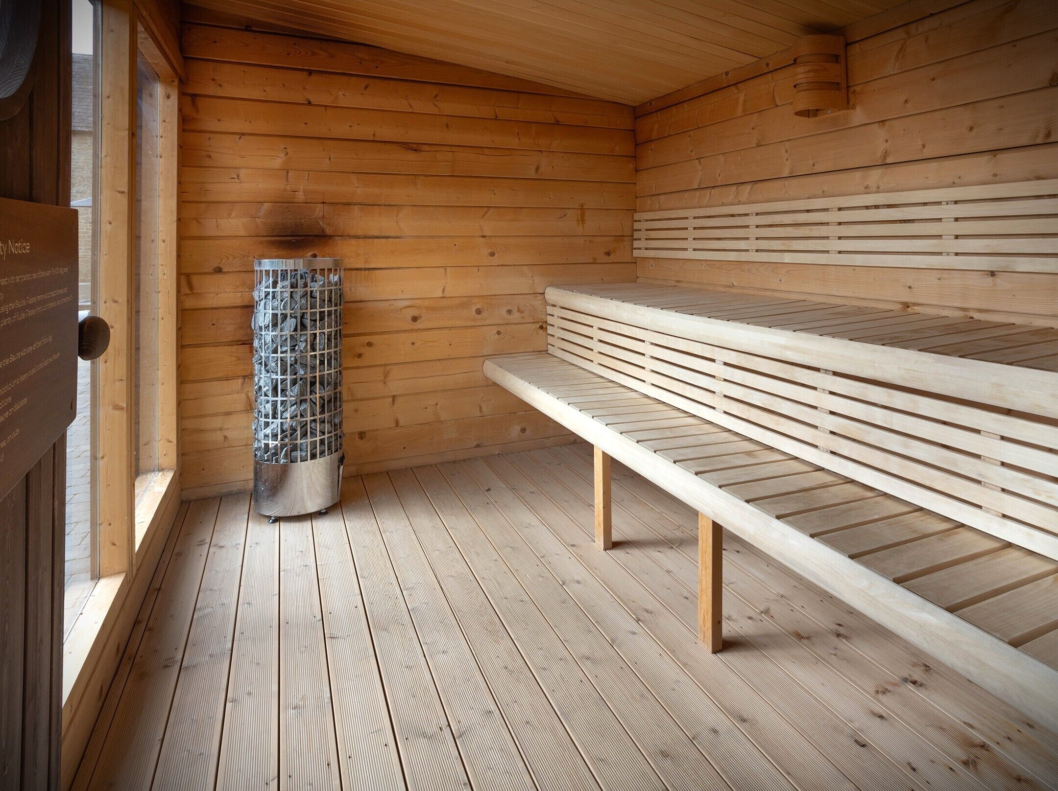 A sauna room with wooden walls and benches.