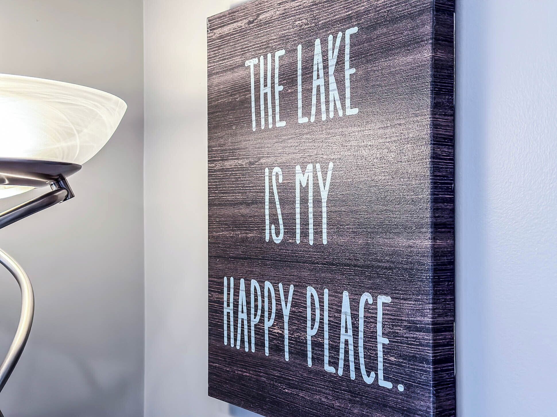 A wall with a sign that reads "THE LAKE IS MY HAPPY PLACE."