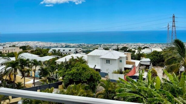 Zona residencial a la costa, amb cases, palmeres i vistes al mar.
