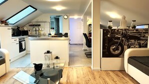 A compact living space with a kitchenette, a dining area, and a seating area.