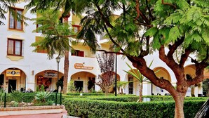 A building with multiple arches and a sign for 'Finos Gin & Wine Bar'. - Villa with private infinity pool close to Port (AN)