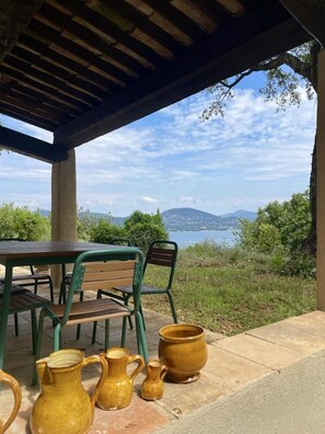 Relax on the patio with a scenic view of the water and mountains.