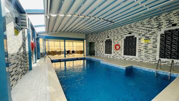 Indoor pool, open 7:00 AM to 10:00 PM, sun loungers, lifeguards on site